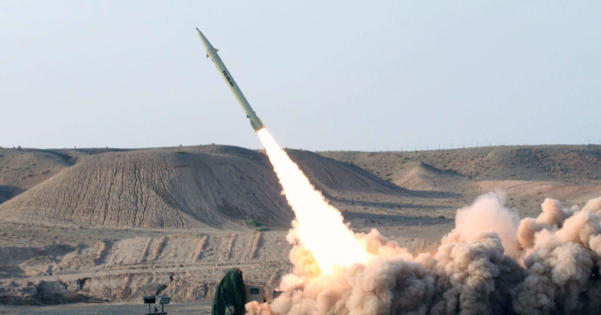 "A ballistic missile launching into the sky from a desert terrain with thick smoke clouds, representing Iran's missile capabilities."