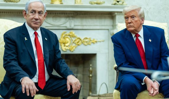 "Donald Trump and Benjamin Netanyahu sitting together during a strategic meeting regarding the Iran operation."